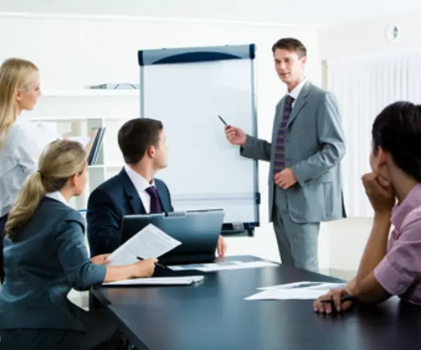 A presenter in a boardroom