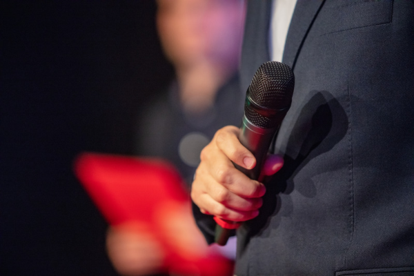 emcee holding mike at awards ceremony