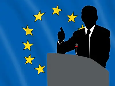 Silhouette of a speaker at a podium with the European flag