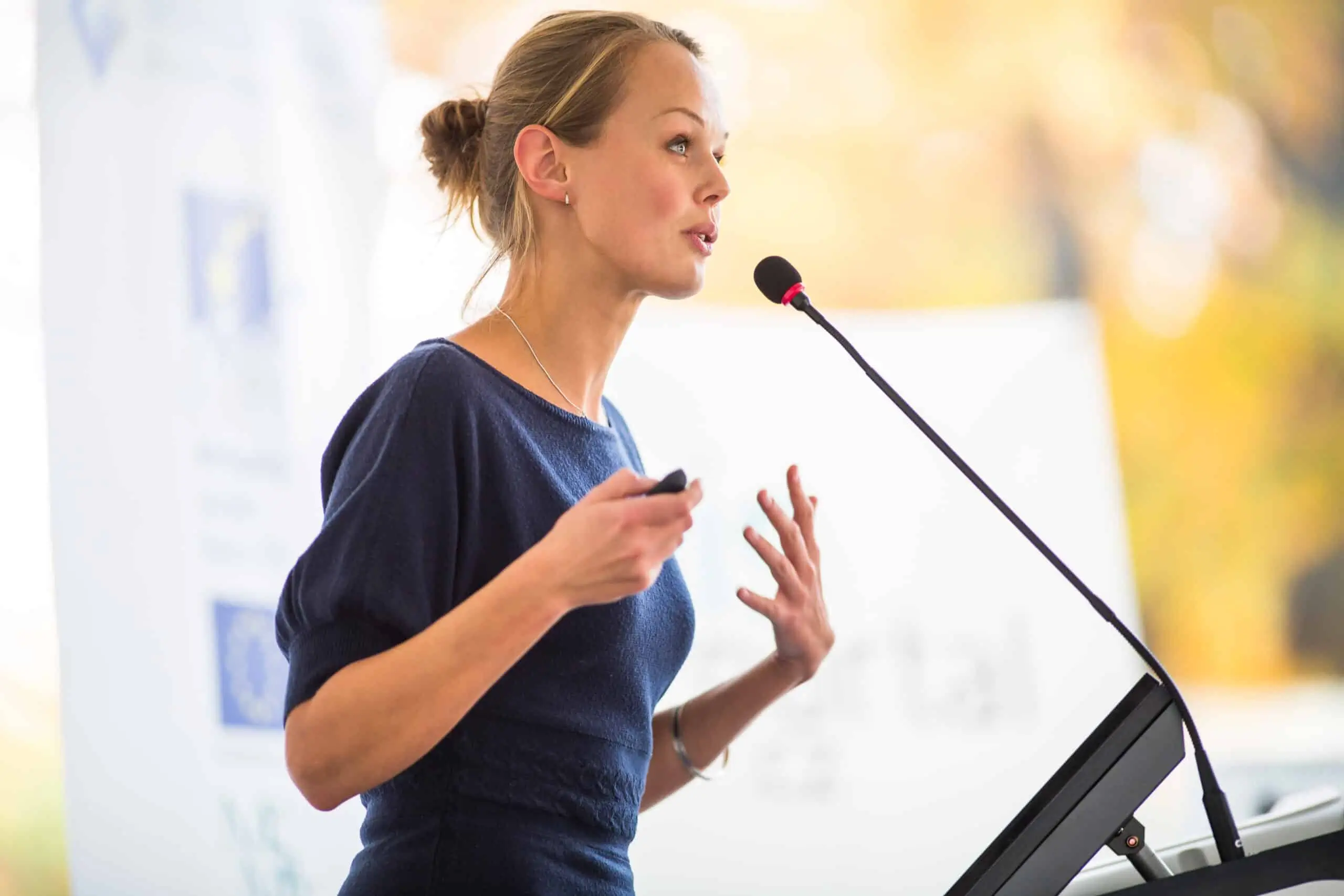 A woman presenting on stage